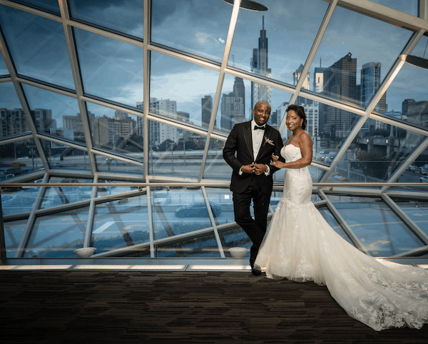 bride and groom with Philadelphia skyline in the background