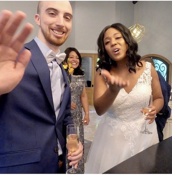 bride and groom waving to guests on Zoom