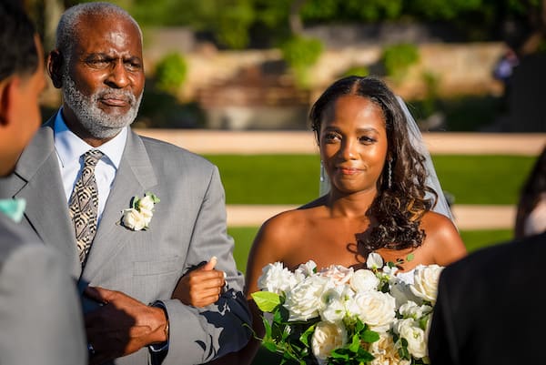 bride being escorted down the aisle by her uncle