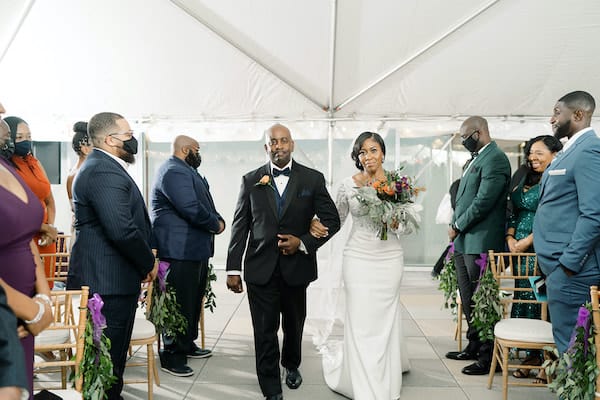 bride being escorted down the aisle by her father at her Independence Visitor Center wedding in Philadelphia