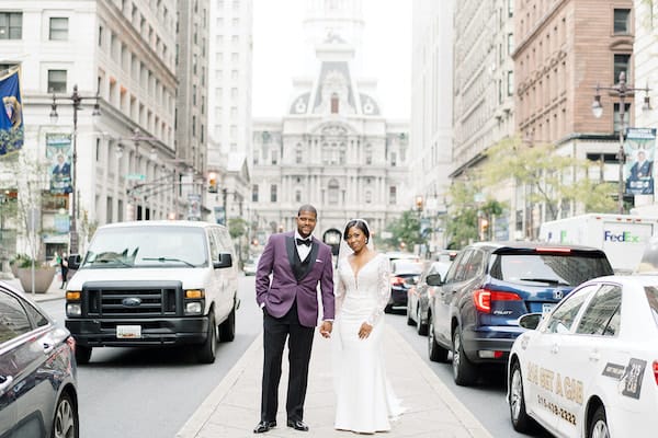 bride and groom on Board Street in front of Philadelphia City Hall