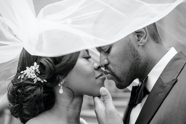 Philadelphia bride and groom kissing under her wedding veil