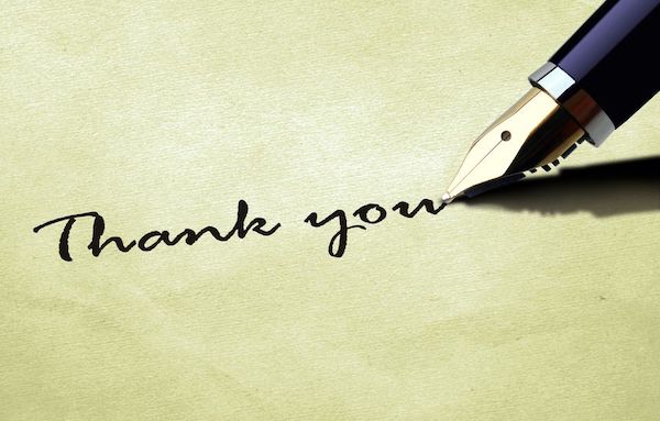 Calligrapher writing Thank You with an ink pen