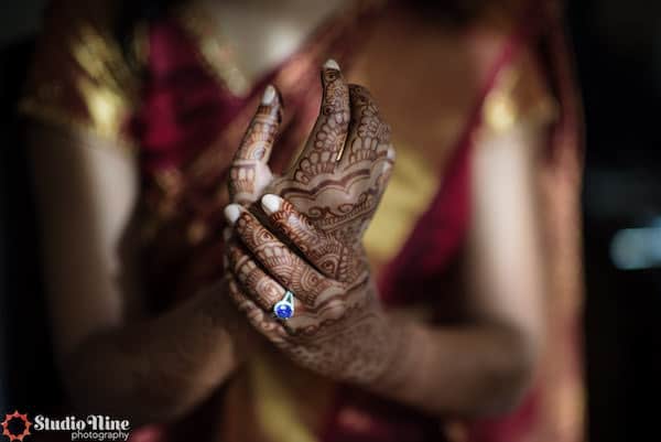 hands of a South Asian bride with intricate henna