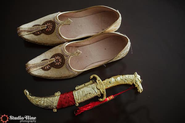 gold shoes and accessories for a South Asian groom