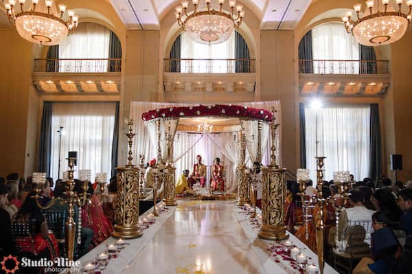 Gold mandap and aisle decor at a Philadelphia South Asian wedding ceremony