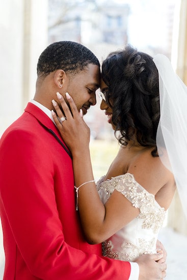 JUST MARRIED, groom in red jacket posing with his bride after their intimate physically distant Philadelphia wedding