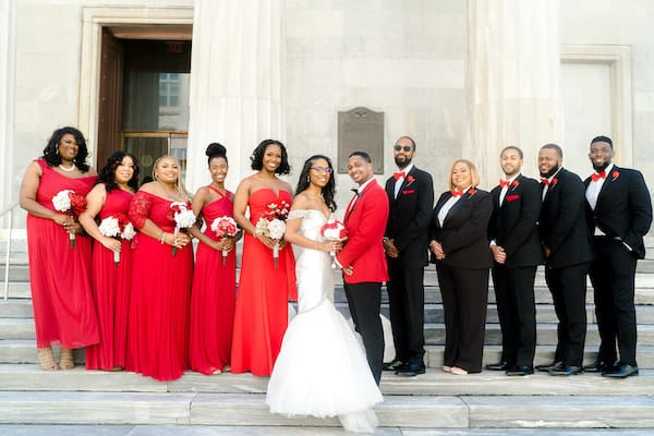 Bride and groom with their wedding party in Old City Philadelphia - red is the groom's favorite color