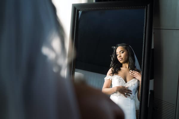 Philadelphia bride look at herself in a mirror at the Notary Hotel