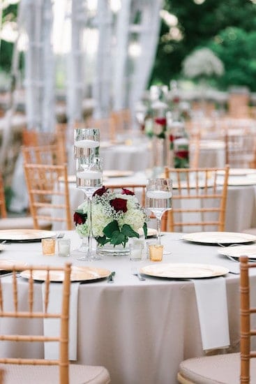 gold, red and white tablescapes on the south terrace at Cairnwood estate