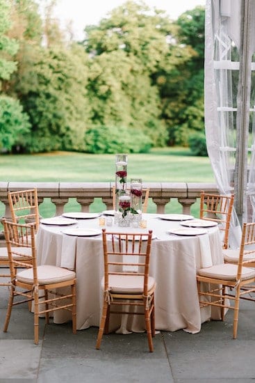 gold, red and white tablescapes on the south terrace at a Cairnwood estate wedding