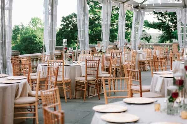 elegant gold, red and white wedding decor on the South Terrace during a wedding at Cairnwood Estates