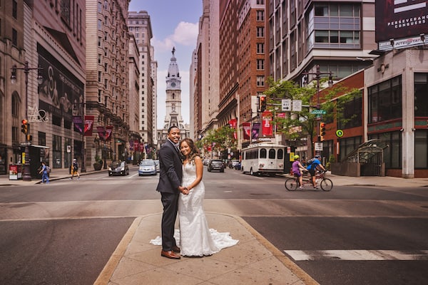 Bride and groom on South Broad Street in front of Philadelphia's City Hall