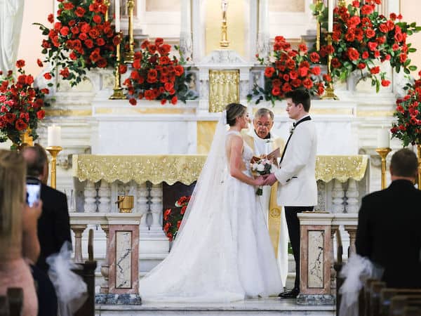 bride and groom exchanging wedding vows at The National Shrine of St Rita of Cascia in Philadelphia