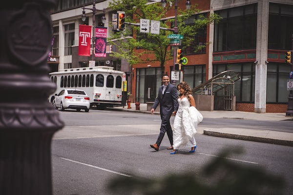 bride and groom crossing South Broad Street in Philadelphia