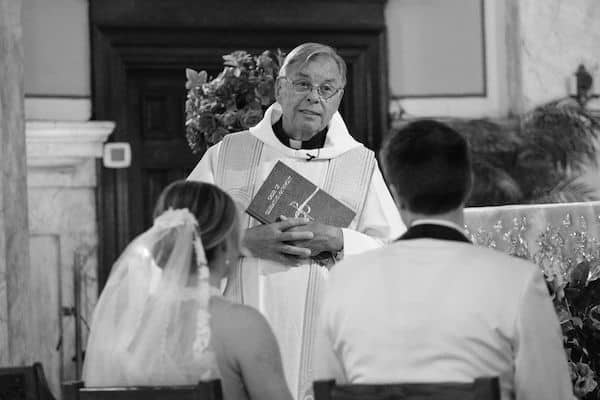 Priest speaking to bride and groom during their Philadelphia wedding