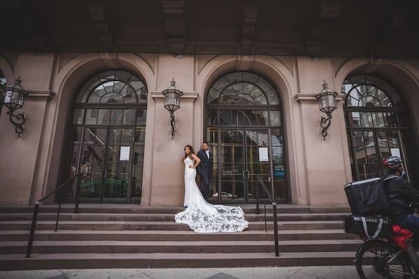 bride and groom in front of the Academy of Music in Philadelphia