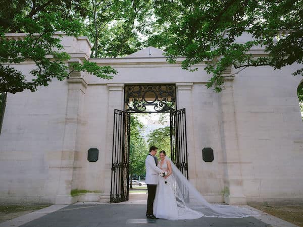 bride and groom at the gate to the Rodin Museum in Philadelphia