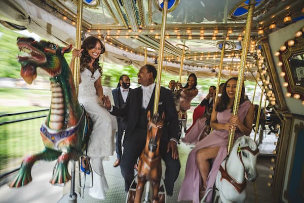 bride and groom with wedding party riding the Park Liberty Carousel in Franklin Square