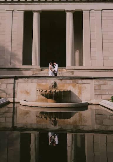 reflection of bride and grooming the fountain at the Rodin Museum in Philadelphia