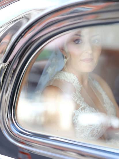 bride riding to her wedding in a vintage car