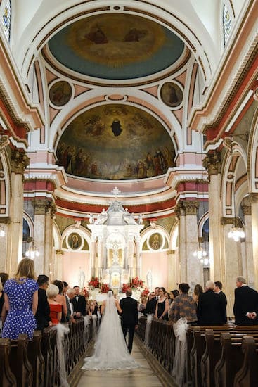 bride and her father walking down the aisle at The National Shrine of St Rita of Cascia in Philadelphia