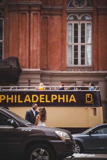 Philadelphia double decker tour bus stops as bride and groom have their first look in front of the Academy of Music