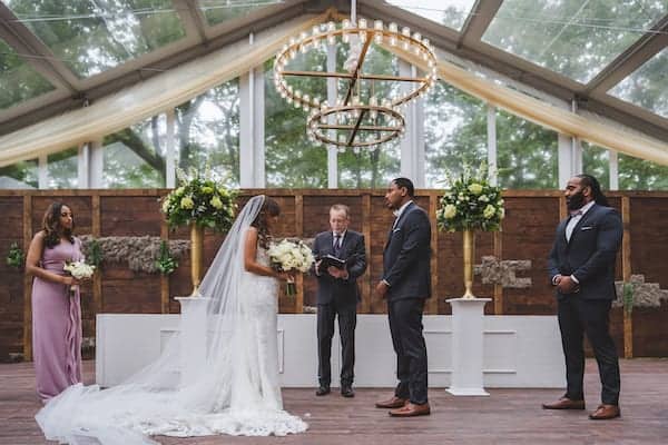 bride and groom exchanging wedding vows at their Cescaphe's Franklin's View wedding in Old City Philadelphia