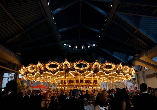 Cocktail reception in front of the carousel at a wedding at the Please Touch Museum