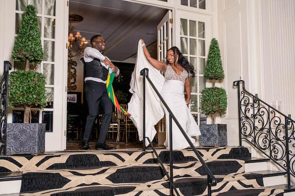 bride and groom holding the flag of Zimbabwe