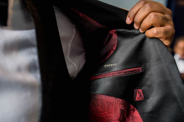 inside of groom's tuxedo is embroidered with his bride's name over his heart