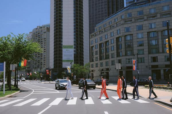 groom crossing the street with his groomsmen like the iconic Beatle's Abby Road photo