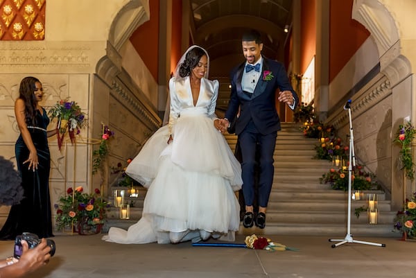 Black bride and groom jumping the broom at their Philadelphia Academy of Fine Arts wedding 