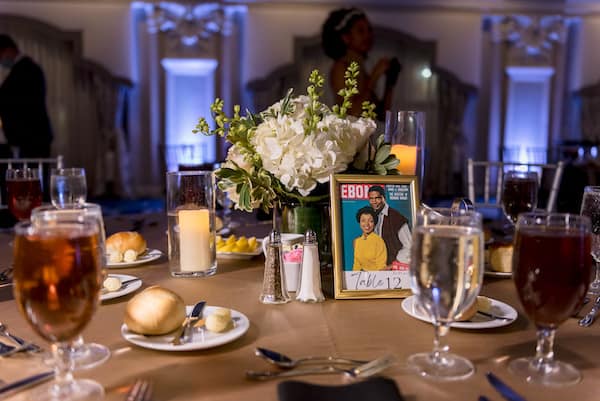 PAFA wedding with table numbers showing pictures of famous black couples