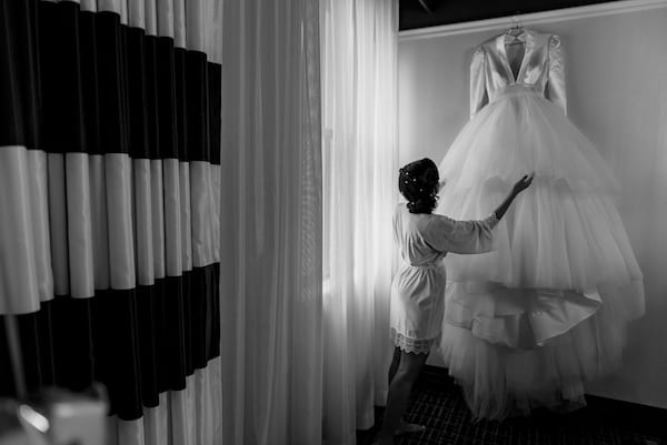 Pennsylvania Academy of Fine Arts wedding bride looking at her wedding gown 