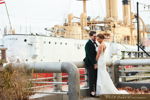 Bride and groom posing for photos on Penn's Landing