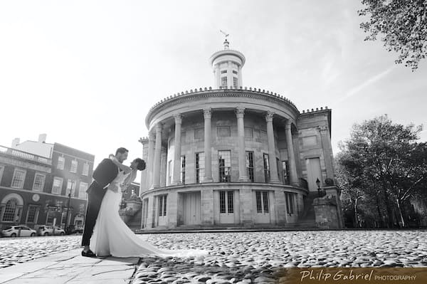 Black and white portrait of a bride and groom in from=nt of Old City's Merchants Exchange