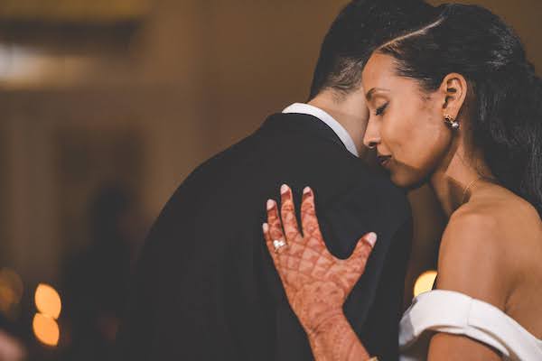 bride holding her groom during their first dance