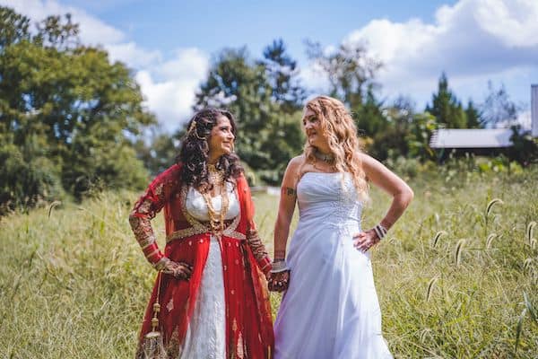 Two brides in a field at Thornbury Farm CSA near West Chester PA