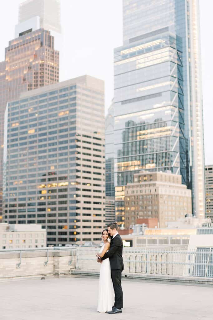 Bride and groom in front of Philadelphia skyline at The Franklin Institute