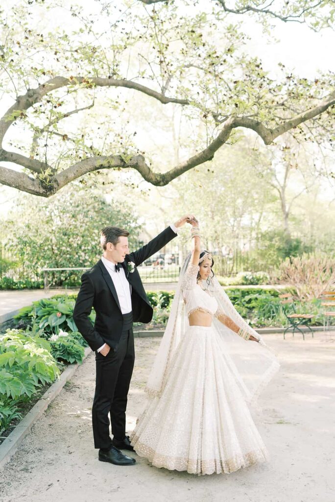 Bride and groom dance under large trees at their Rodin Museum wedding