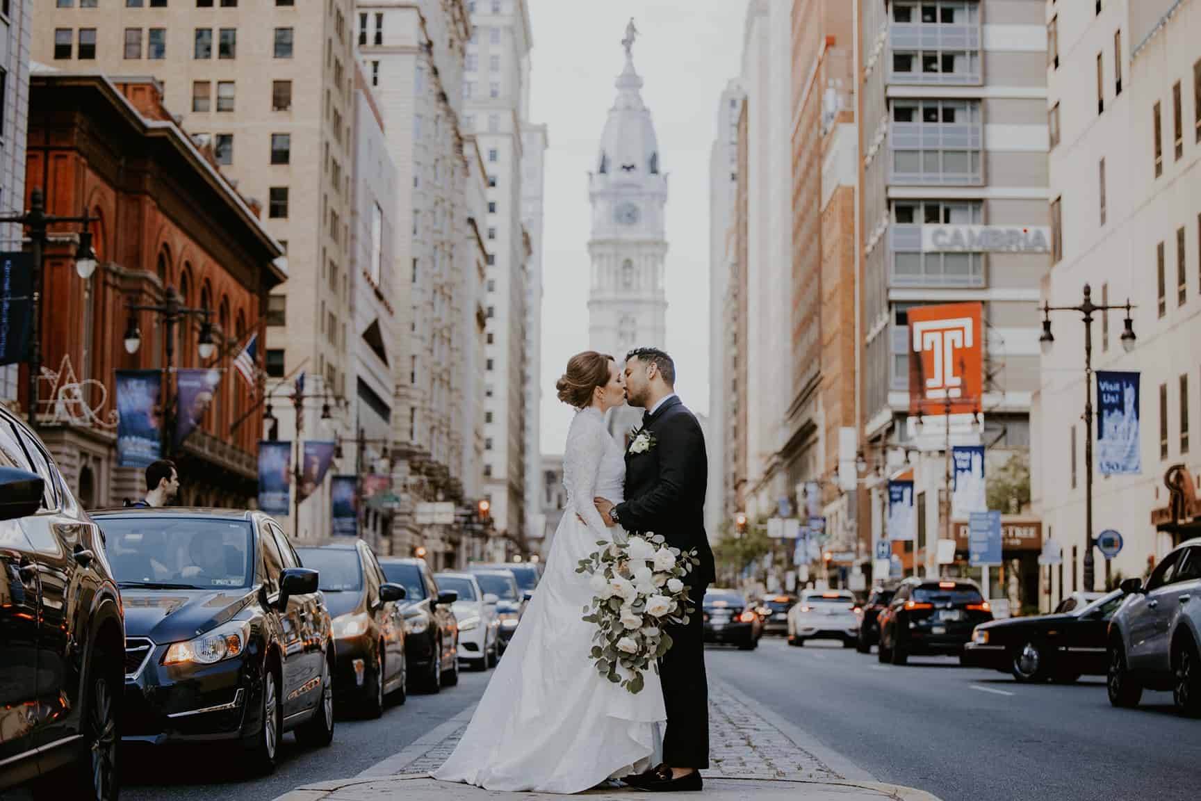 Bride and groom kiss in downtown Philadelphia