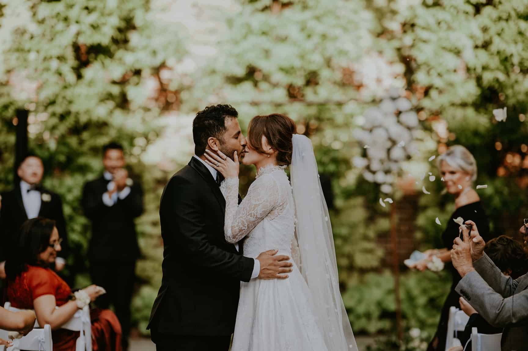 Bride and groom kiss during College of Physicians wedding ceremony