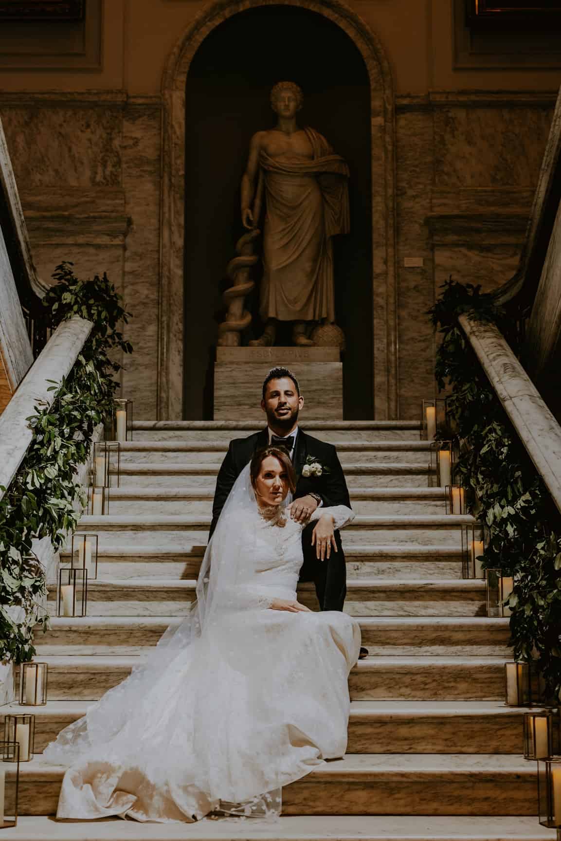 Couple sit in the College of Physicians marble rotunda