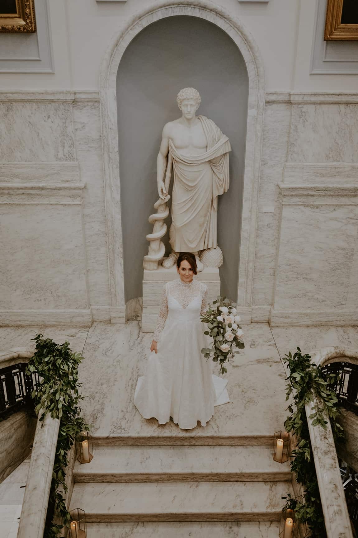 Bride in front of statute at College of Physicians wedding