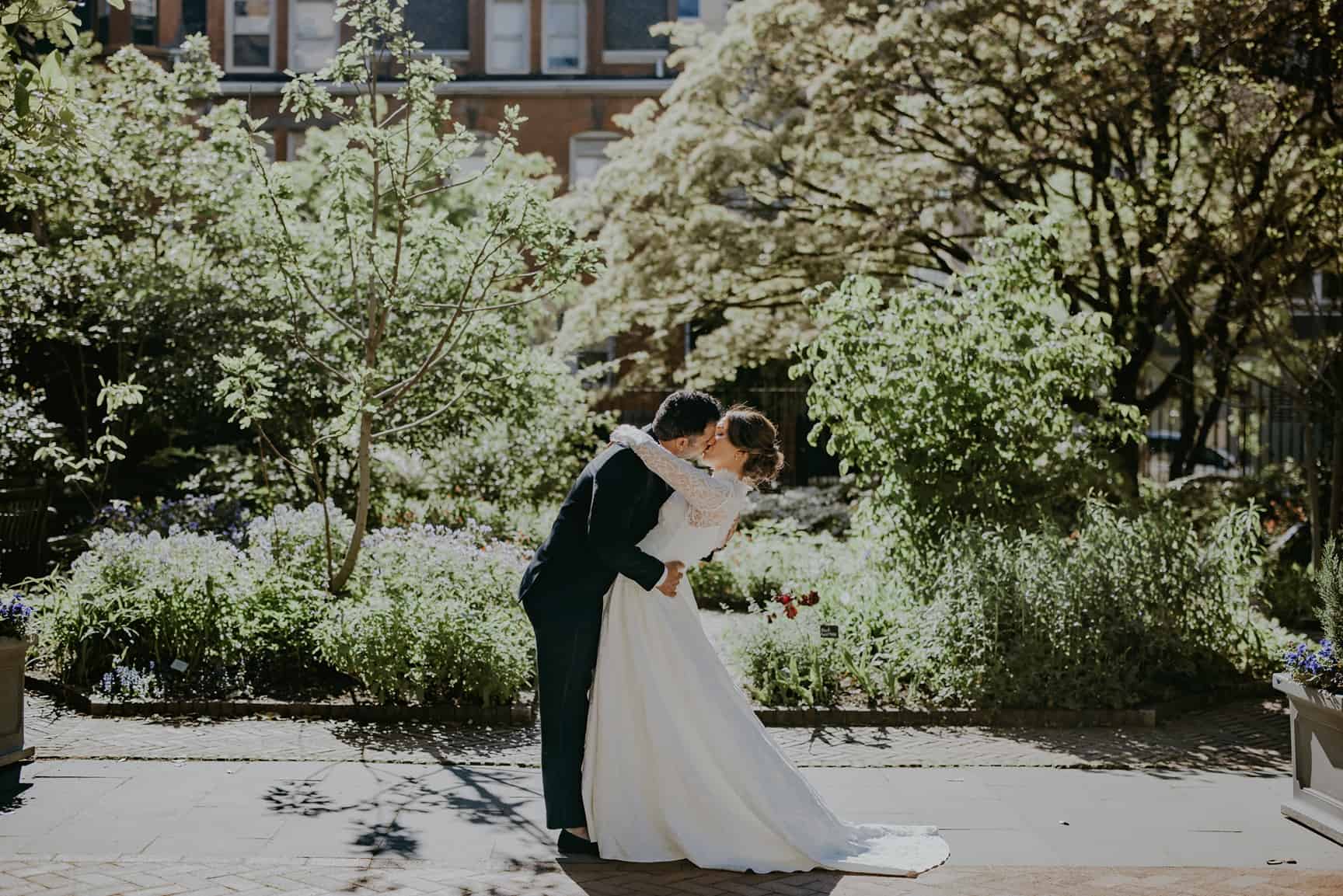 Bride and groom kiss in the College of Physicians garden and veranda