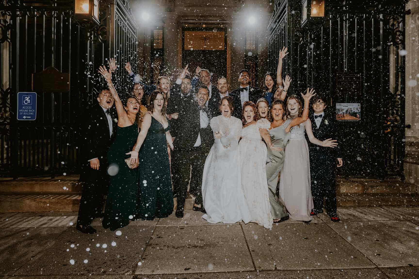 Wedding party pop champagne outside of College of Physicians Philadelphia