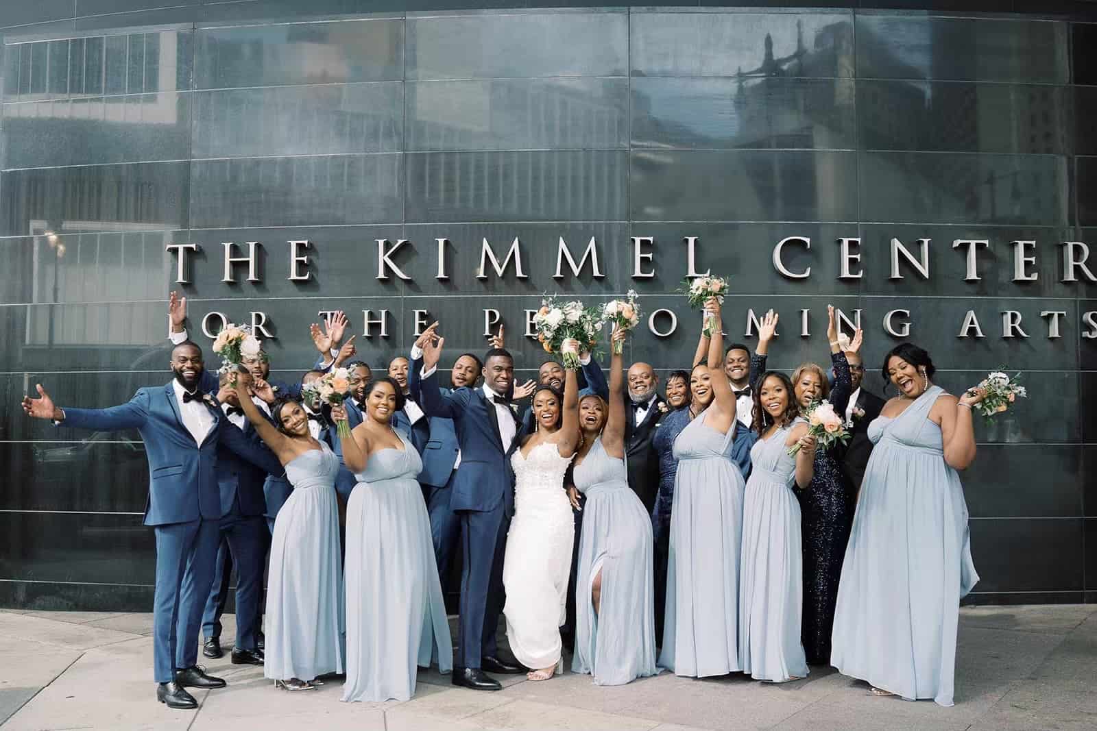 Wedding party poses for photos outside of the Kimmel Center in Philadelphia