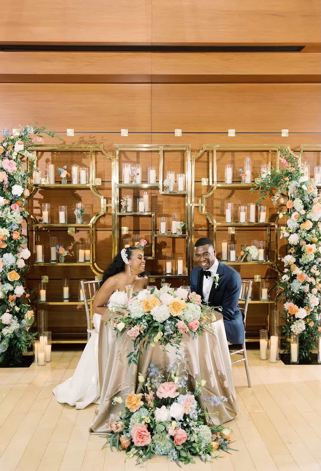 Bride and groom sit at their sweetheart table at the Kimmel Center wedding